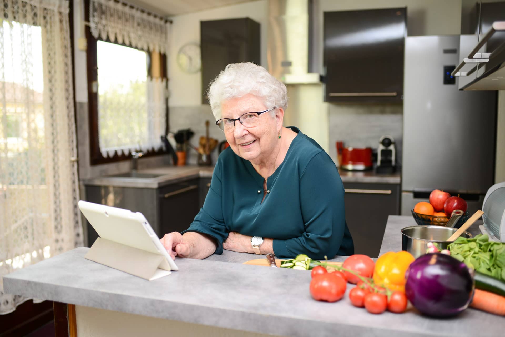 Senior active woman cooking at home