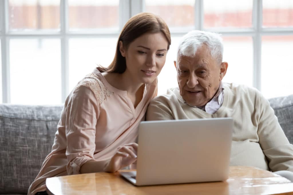 Grown up daughter and old 80s father choose goods or services via internet