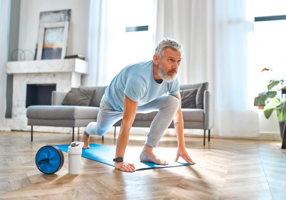 Mature man doing exercises at home