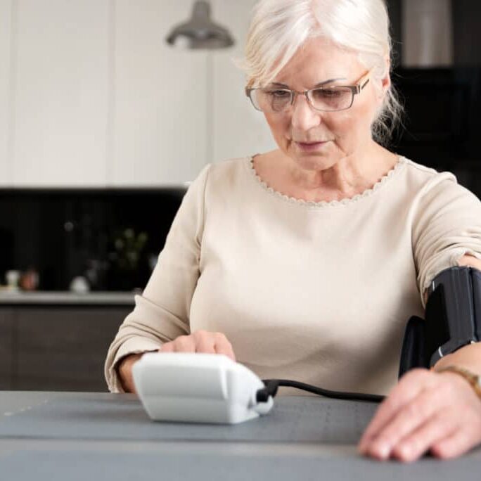 Senior adult woman measuring blood pressure